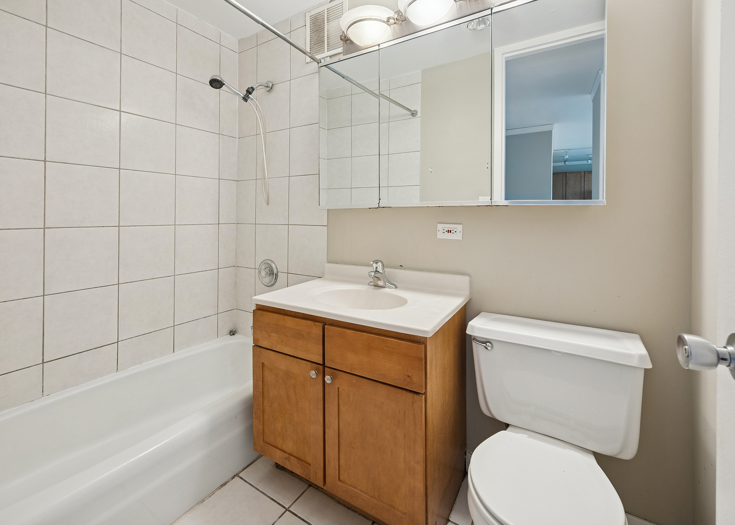 655 West Irving Park Road, Unit 3706 Chicago, IL 60613 - Photo 12 of 16 a bathroom with a sink toilet and shower