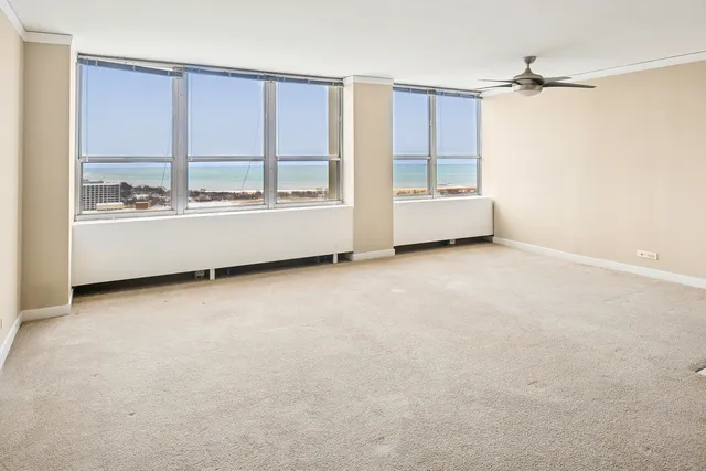 a view of kitchen with refrigerator cabinets and a window