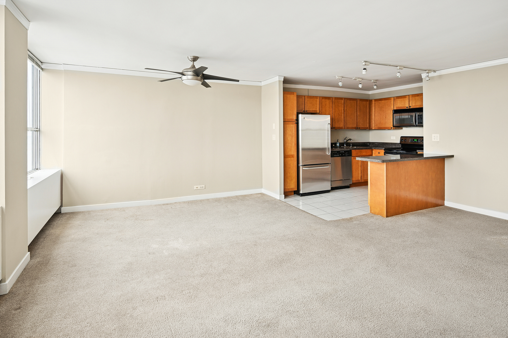 655 West Irving Park Road, Unit 3706 Chicago, IL 60613 - Photo 5 of 16 a view of kitchen with refrigerator cabinets and a window