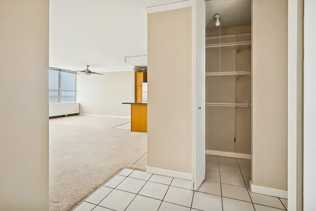 an empty room with wooden floor and window