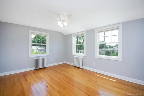 a view of an empty room with wooden floor