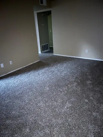 a view of an empty room with a fireplace