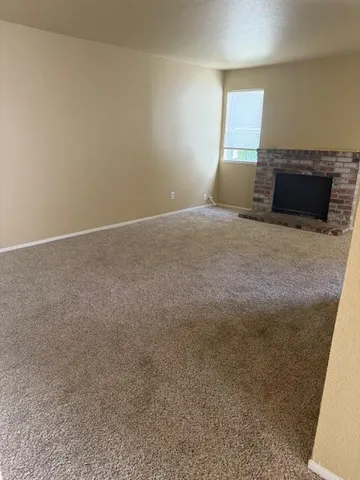 a view of a car parked in front of a house with a yard