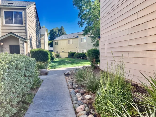 a view of street along with house and trees
