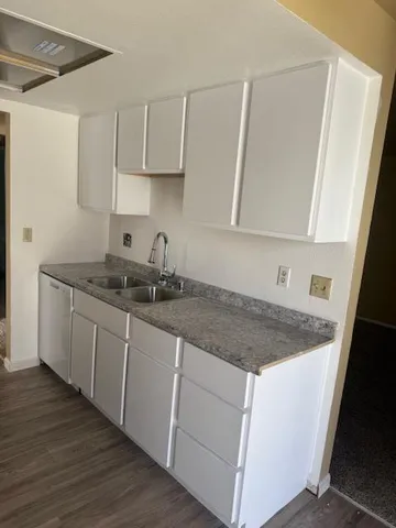 a kitchen with stainless steel appliances granite countertop a sink stove and cabinets