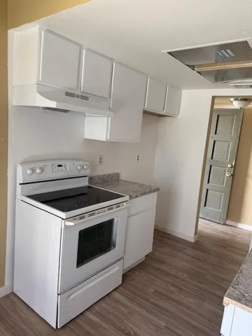 a stove top oven sitting inside of a kitchen