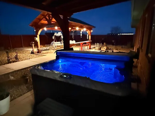 a view of a swimming pool with outdoor seating
