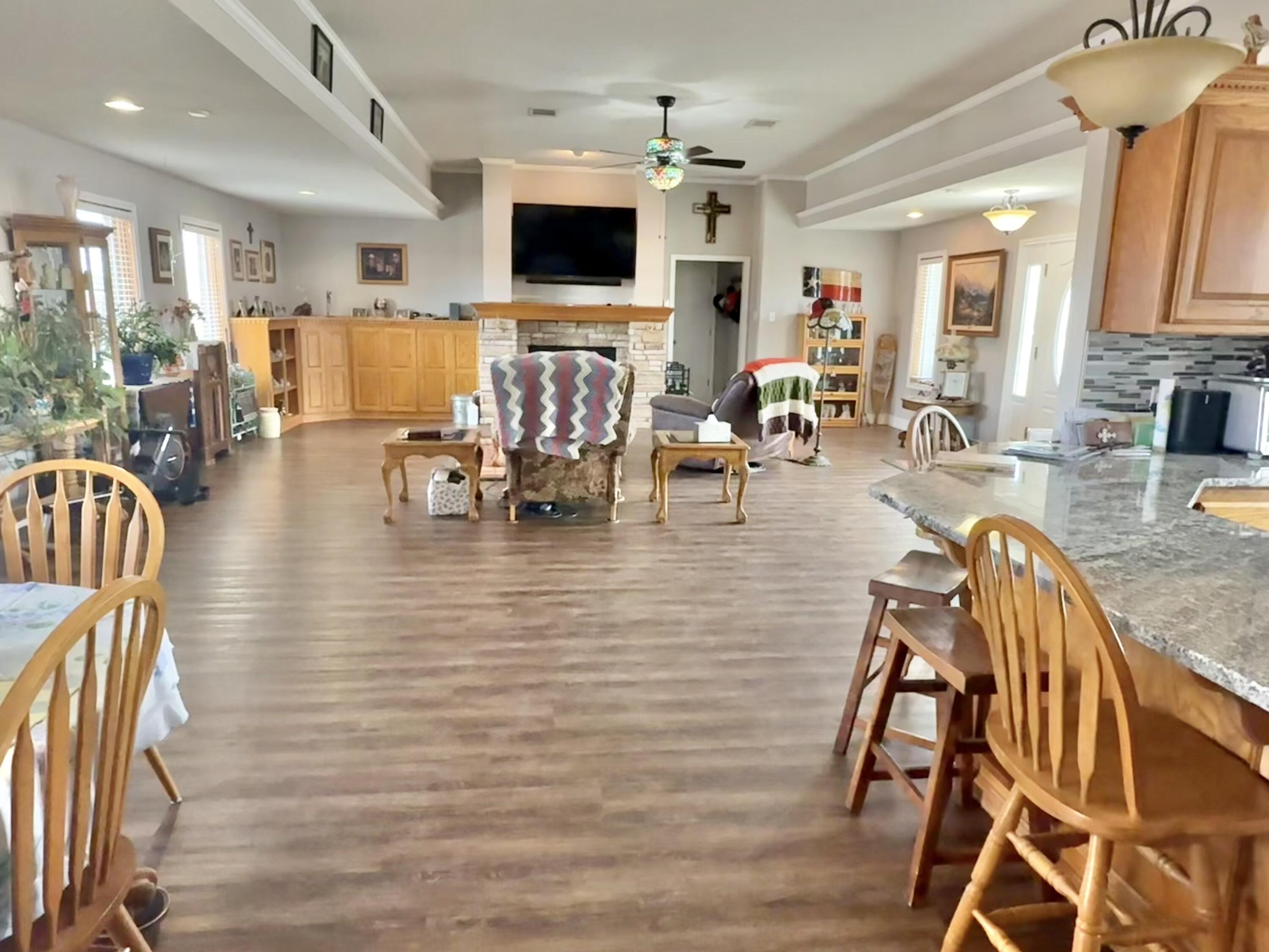 19 Ridgeview Farwell, TX 79325 - Photo 11 of 40 a living room with furniture a flat screen tv and kitchen view