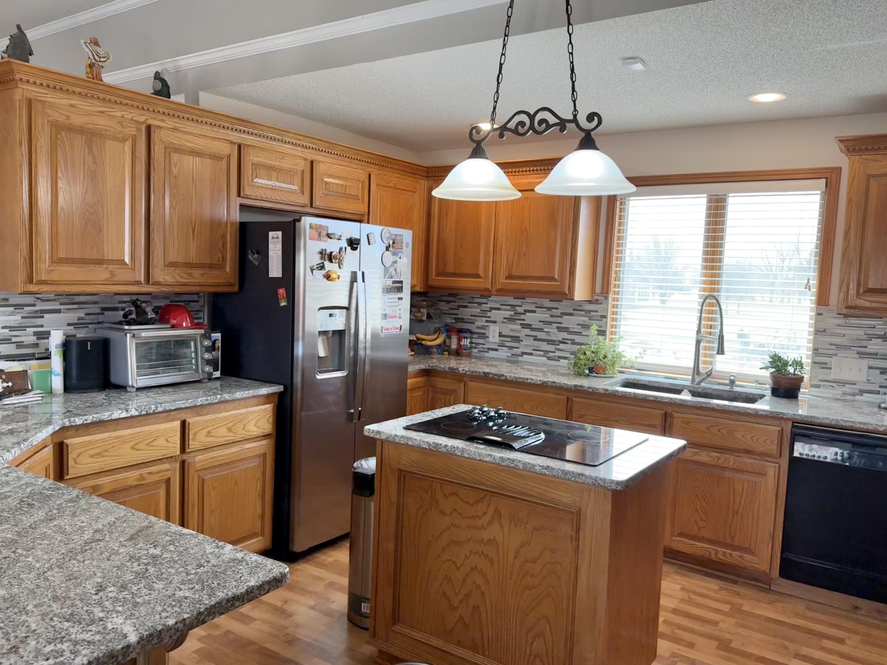 19 Ridgeview Farwell, TX 79325 - Photo 13 of 40 a kitchen with stainless steel appliances granite countertop a sink stove and refrigerator