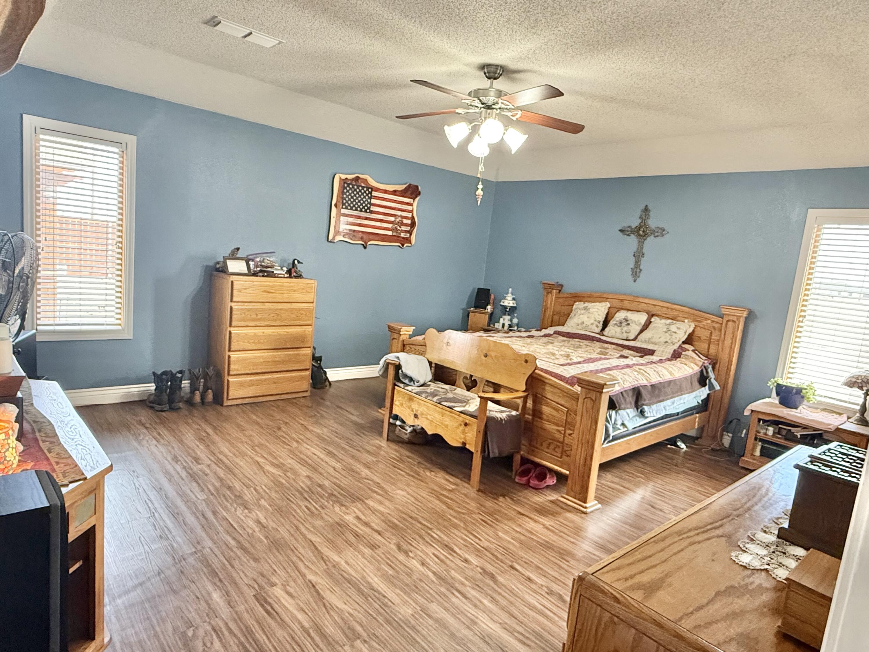 19 Ridgeview Farwell, TX 79325 - Photo 16 of 40 a bedroom with a bed and a chandelier