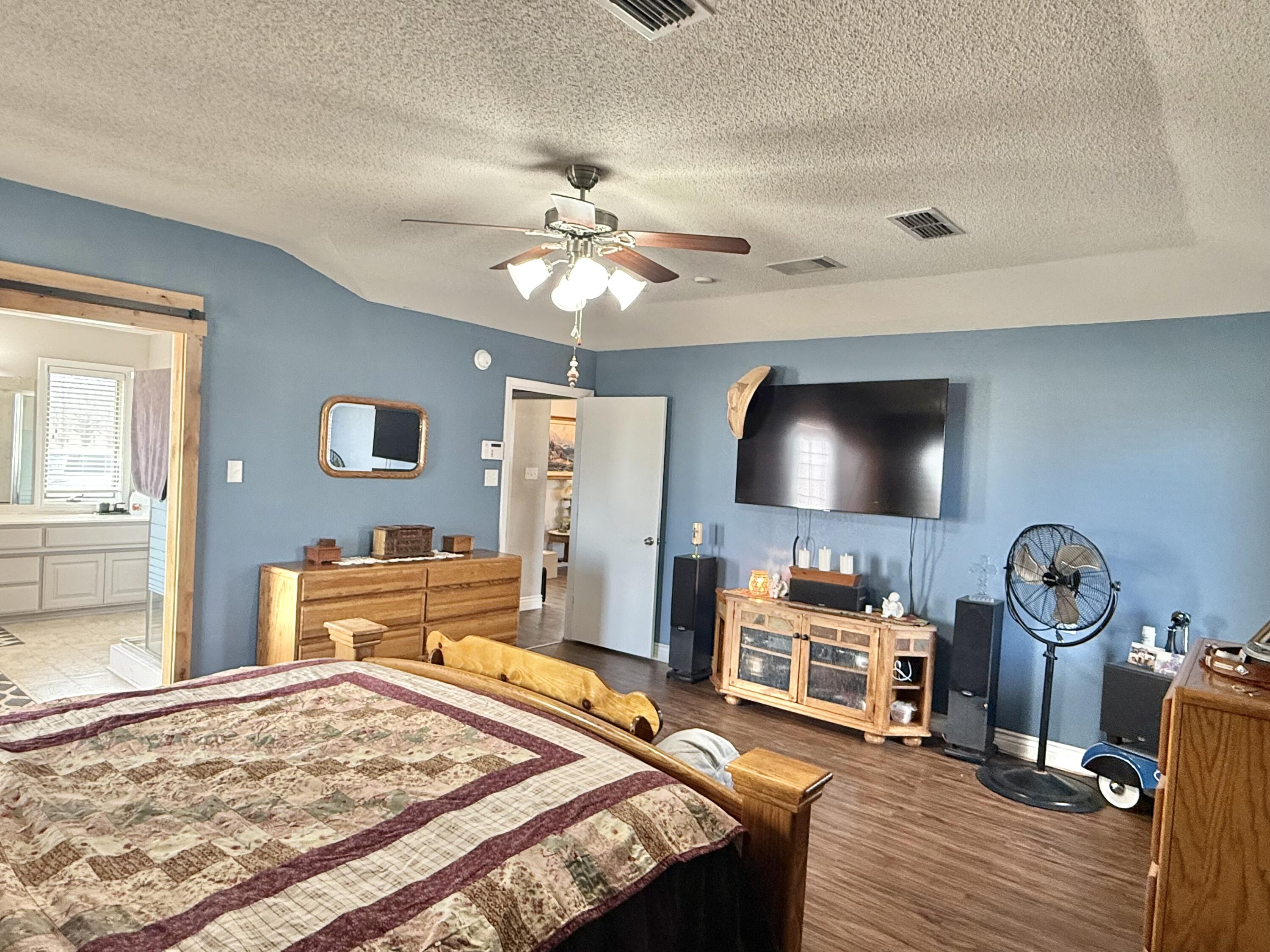 19 Ridgeview Farwell, TX 79325 - Photo 18 of 40 a bedroom with furniture and a chandelier