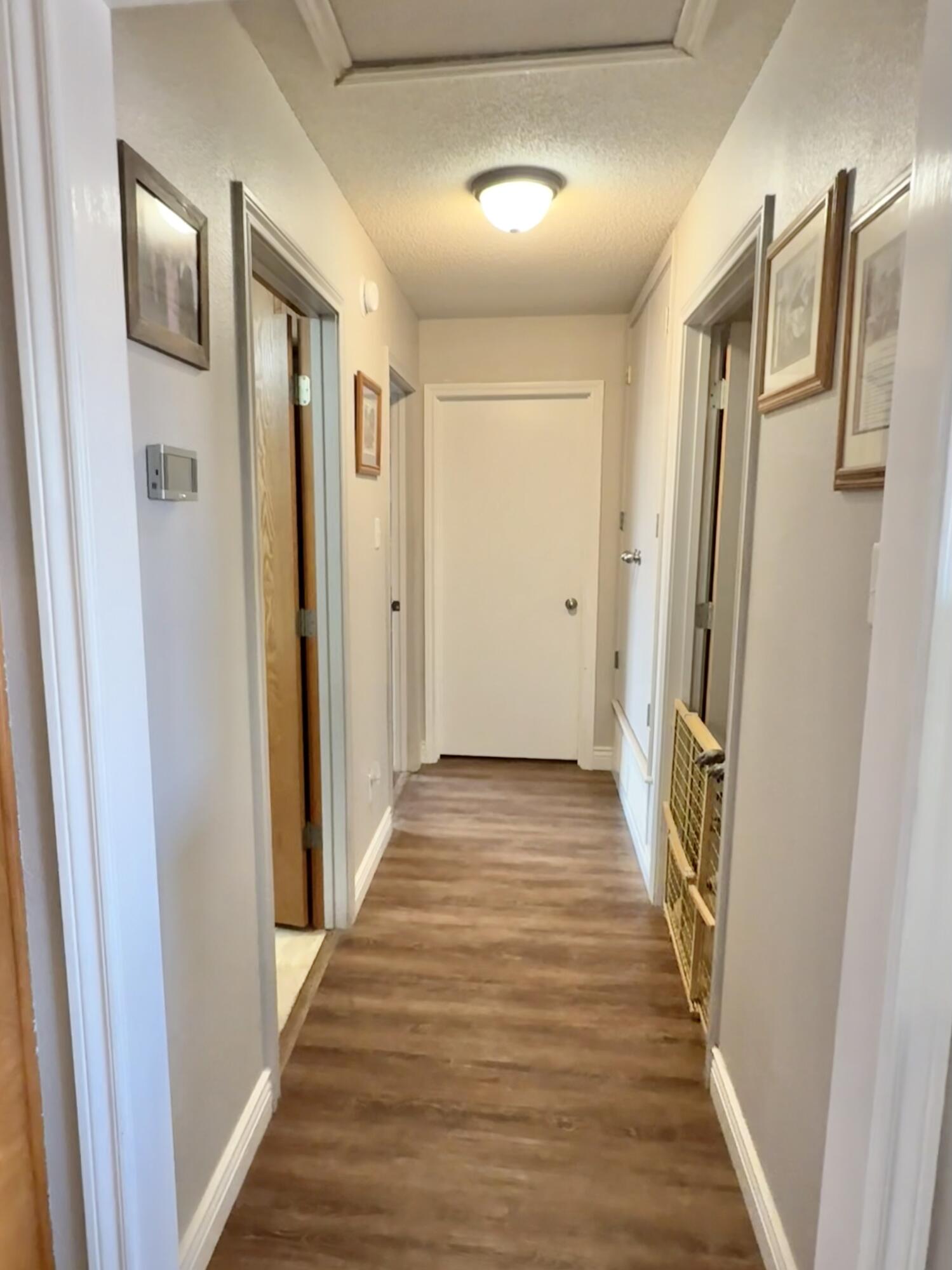 19 Ridgeview Farwell, TX 79325 - Photo 22 of 40 a view of a hallway with wooden floor and staircase
