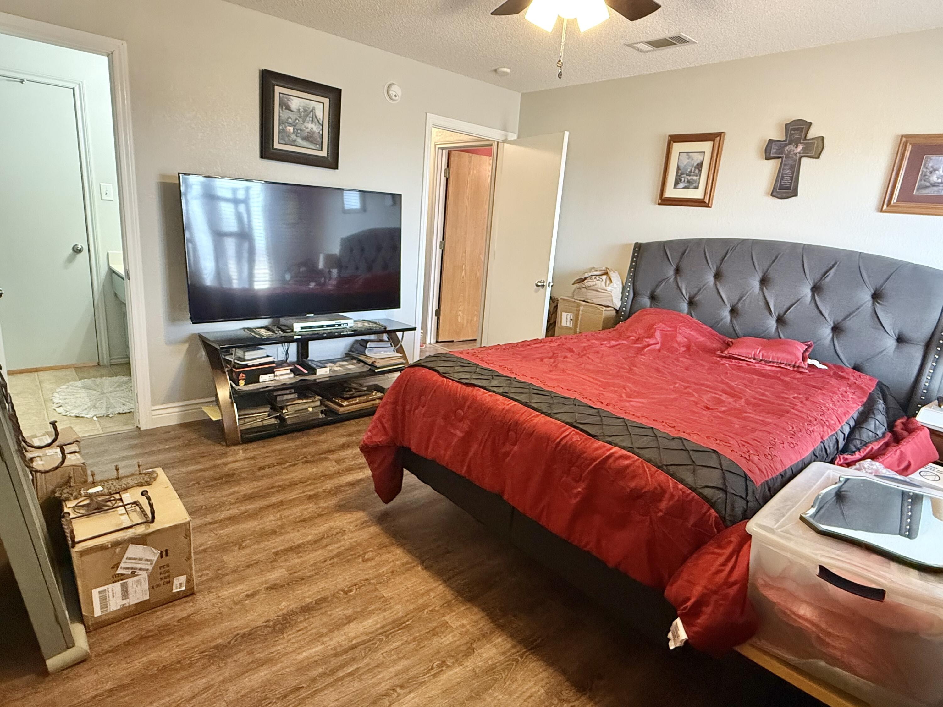 19 Ridgeview Farwell, TX 79325 - Photo 27 of 40 a bedroom with a bed and a flat screen tv