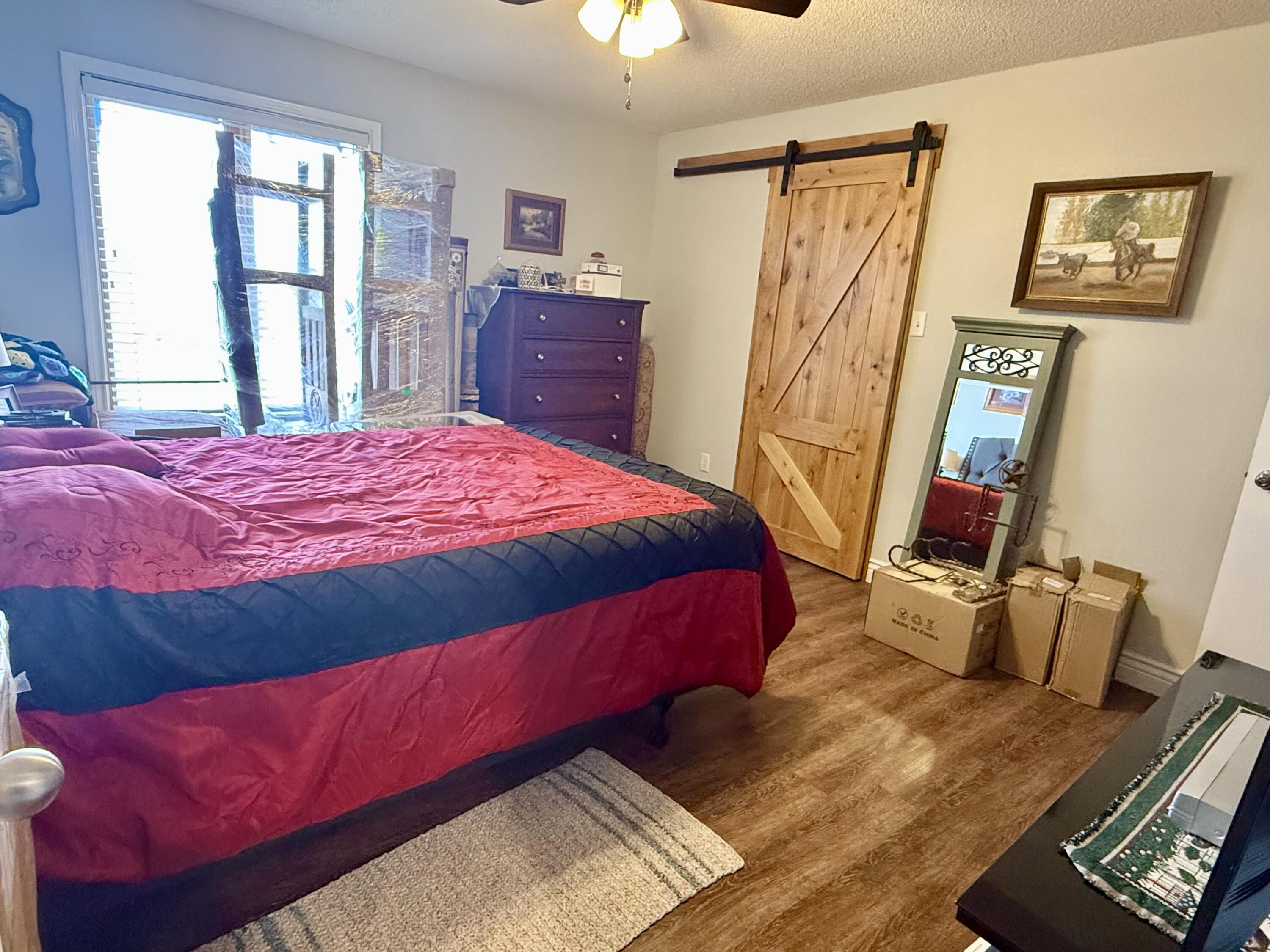19 Ridgeview Farwell, TX 79325 - Photo 28 of 40 a bedroom with a bed and wooden floor