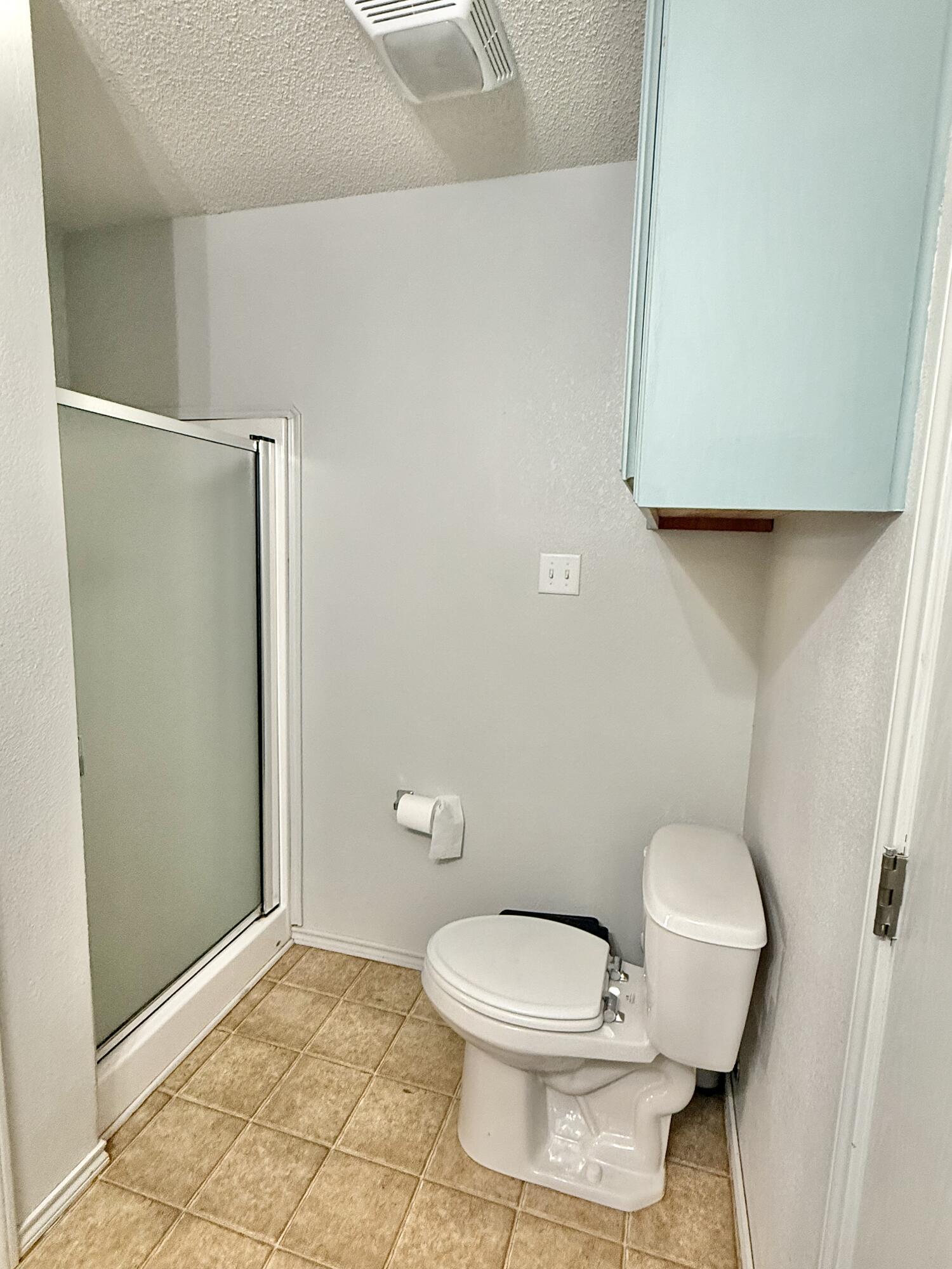 19 Ridgeview Farwell, TX 79325 - Photo 30 of 40 a white toilet sitting next to a shower