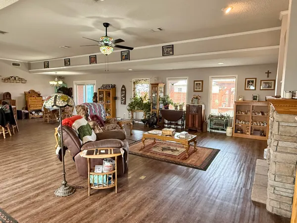 a living room with furniture and wooden floor
