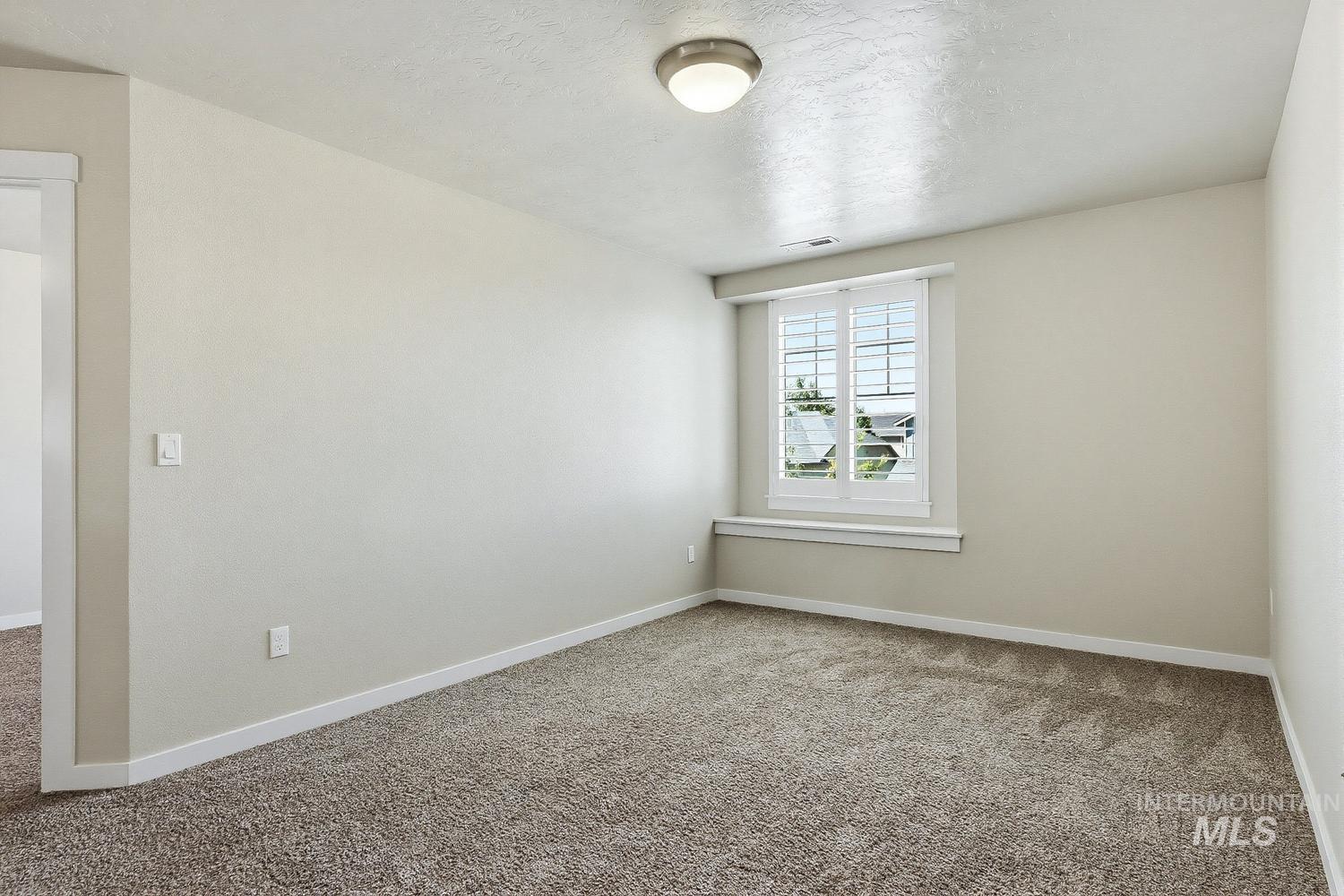 846 North Hidden View Way Star, ID 83669 - Photo 29 of 49 Neutral-toned room featuring a single window with plantation shutters, broadloom carpeting, and a flush-mount ceiling light fixture