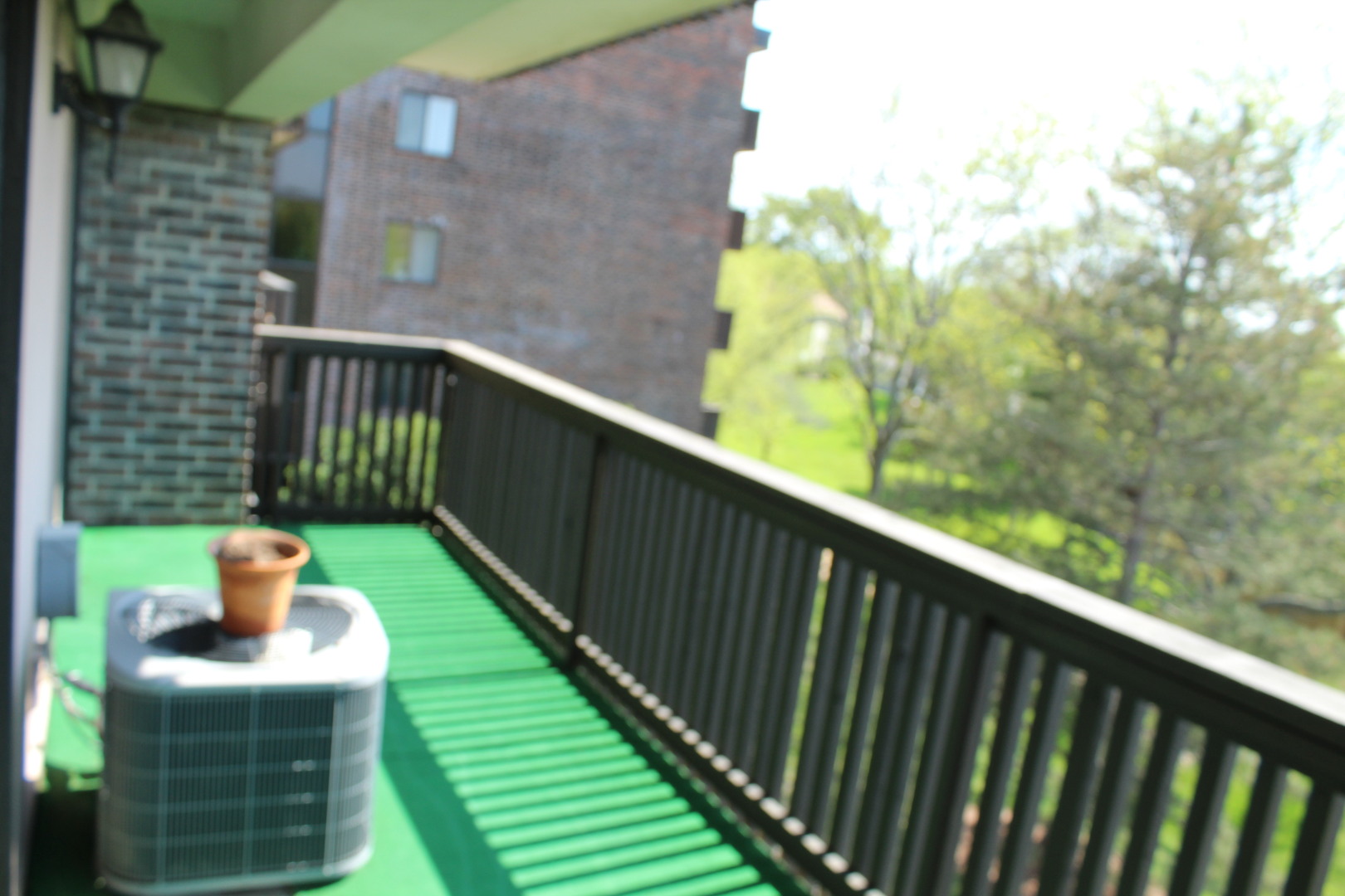920 Vose Drive, Unit 402 Gurnee, IL 60031 - Photo 24 of 42 a balcony with table and chairs