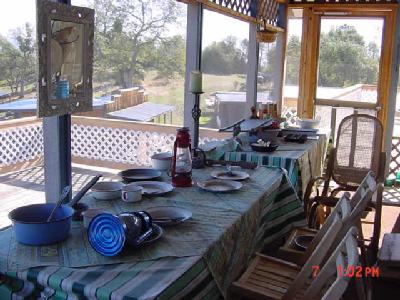 31189 Wyle Ranch Road North Fork, CA 93643 - Photo 5 of 8 This is of the screened in sunporch. If you peek over the railing you can see the top of the western style guest building.