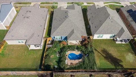 an aerial view of a house with a swimming pool