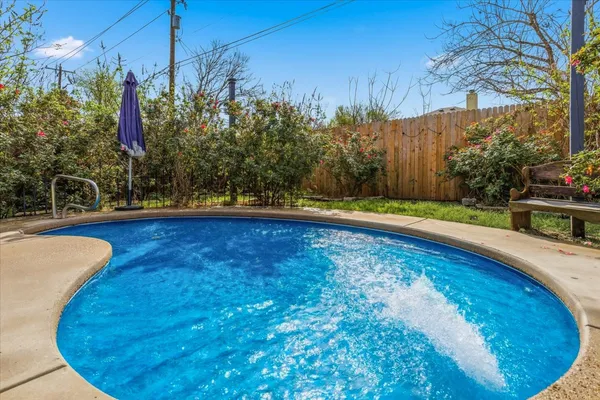 a view of a swimming pool with an outdoor space and seating area