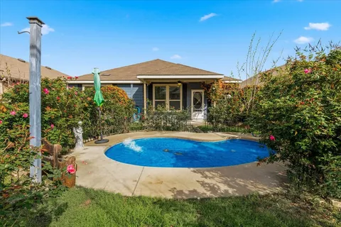 a view of a house with swimming pool and sitting area