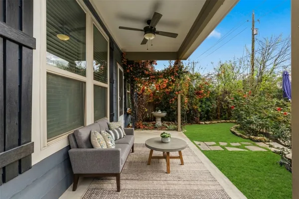 a backyard of a house with table and chairs