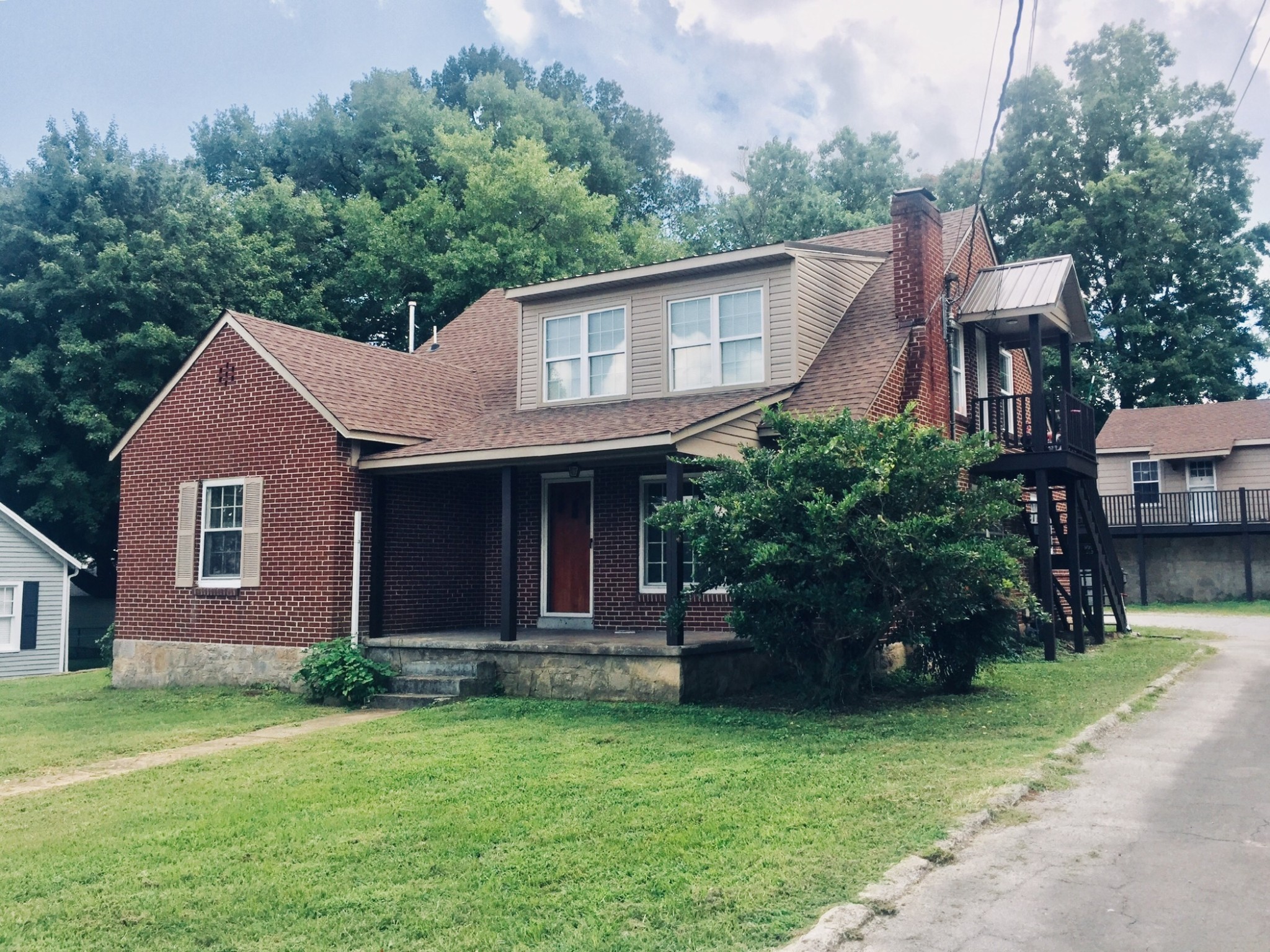 451 East Madison Street Pulaski, TN 38478 - Photo 1 of 16 a front view of a house with a garden