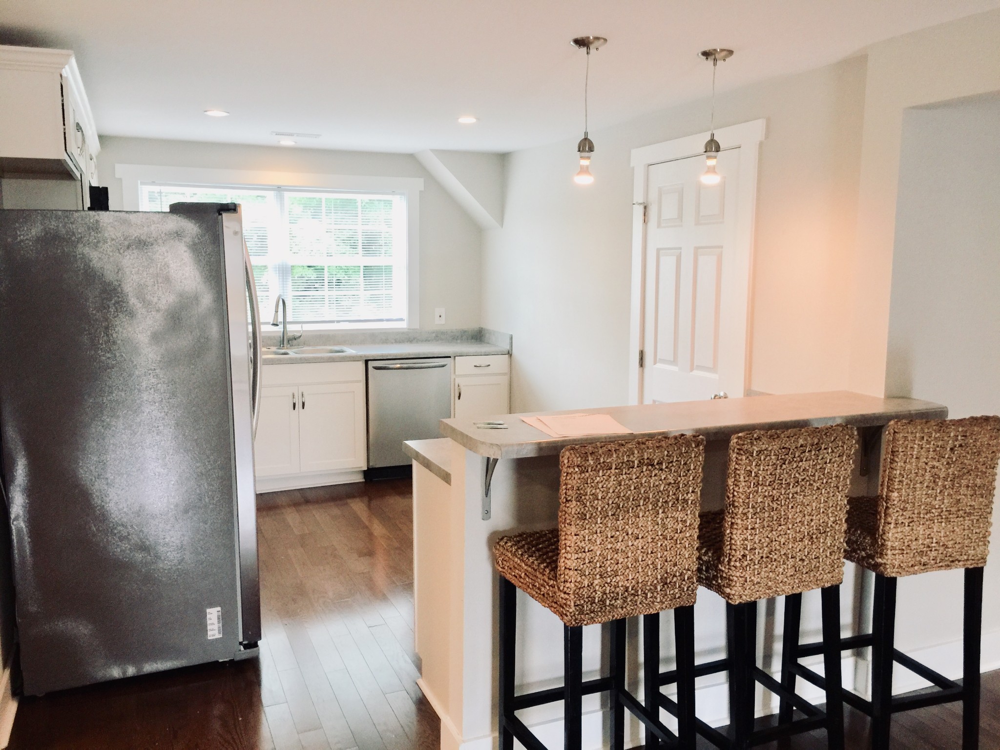 451 East Madison Street Pulaski, TN 38478 - Photo 2 of 16 a kitchen with granite countertop a table chairs sink and cabinets