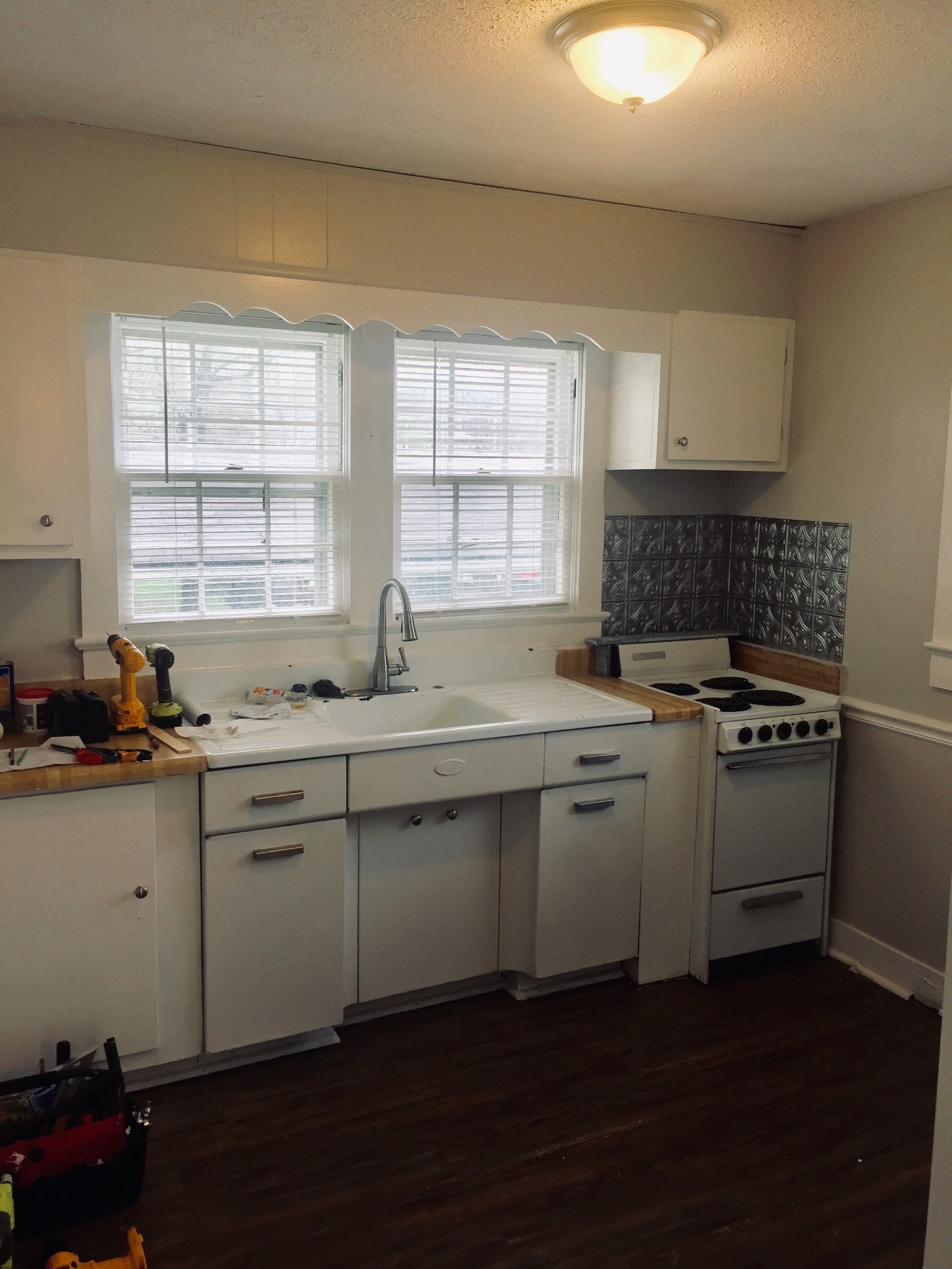 451 East Madison Street Pulaski, TN 38478 - Photo 14 of 16 a kitchen with granite countertop a sink cabinets and wooden floor