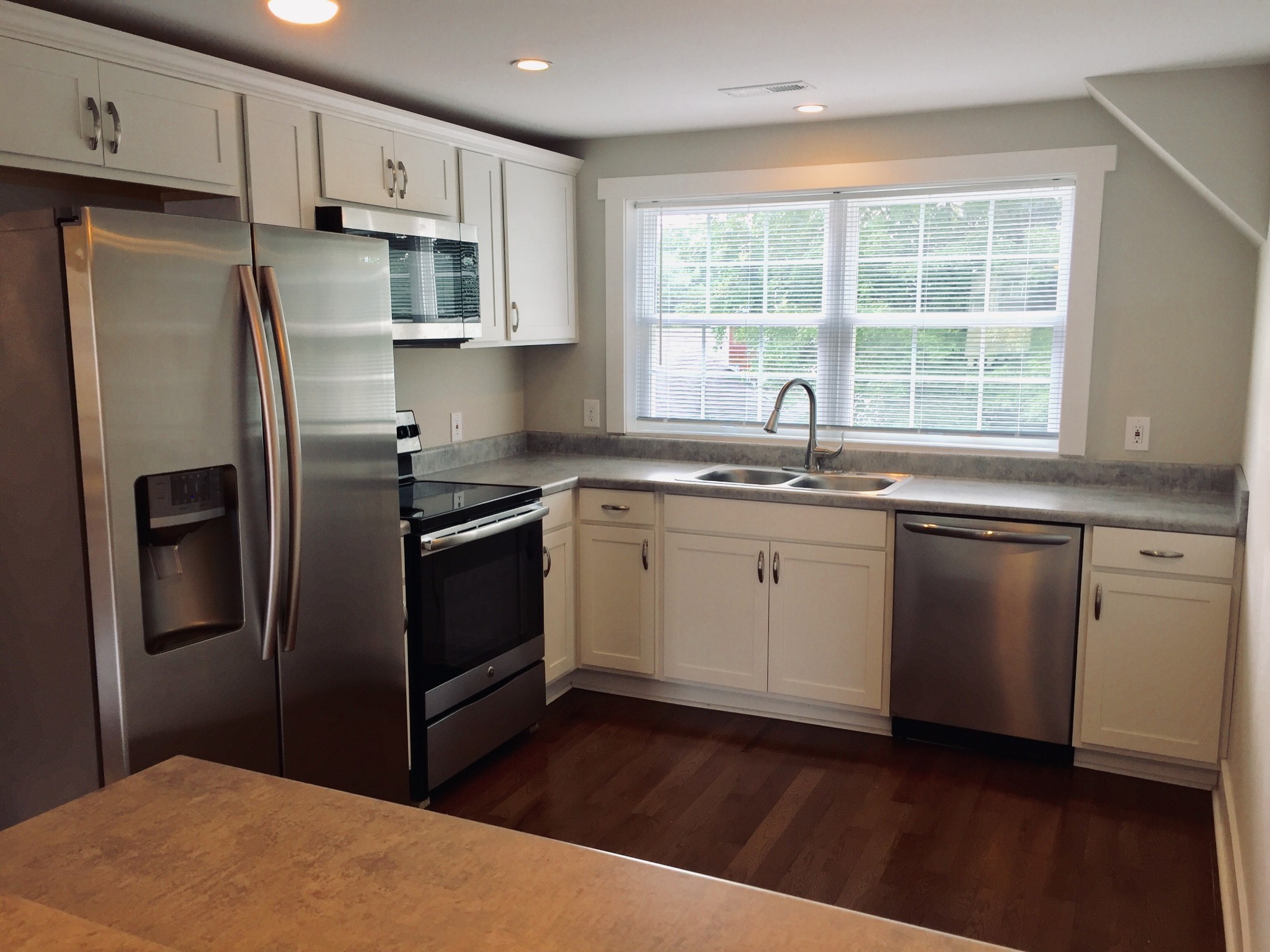 451 East Madison Street Pulaski, TN 38478 - Photo 3 of 16 a kitchen with stainless steel appliances a refrigerator sink and microwave