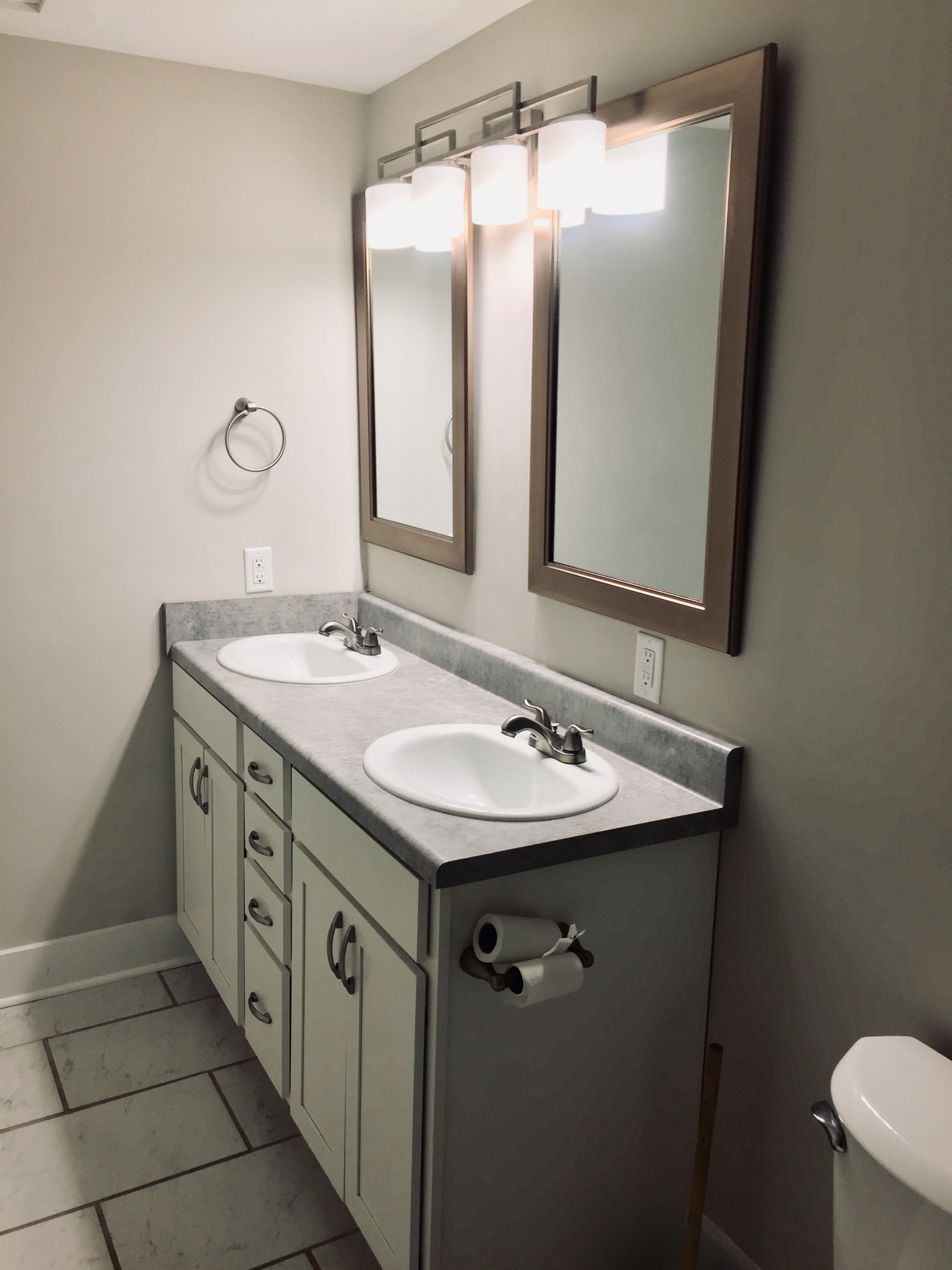 451 East Madison Street Pulaski, TN 38478 - Photo 4 of 16 a bathroom with a double vanity sink and mirror