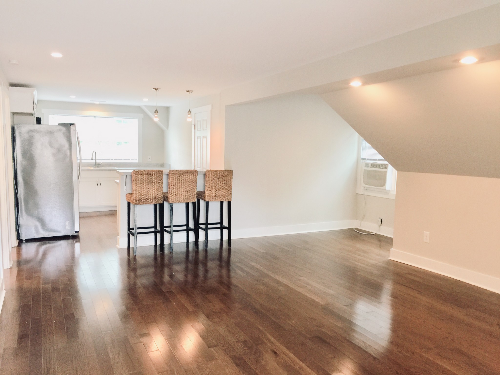451 East Madison Street Pulaski, TN 38478 - Photo 5 of 16 a view of a kitchen with furniture and wooden floor