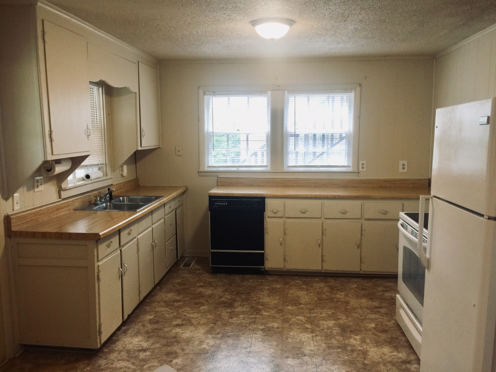 451 East Madison Street Pulaski, TN 38478 - Photo 9 of 16 a kitchen with a sink stove and refrigerator