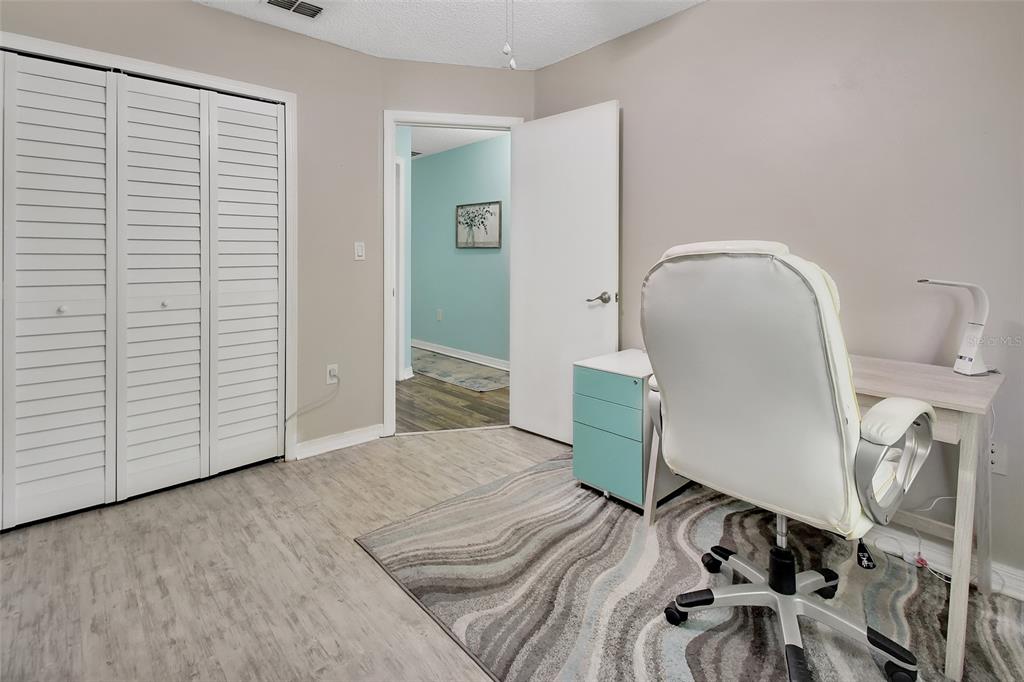 1601 Big Tree Road, Unit 307 South Daytona, FL 32119 - Photo 13 of 18 a view of a bedroom with wooden floor and white walls