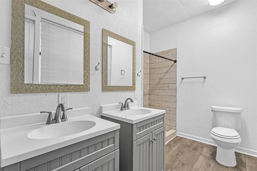 100 West Munson Street Denison, TX 75021 - Photo 8 of 12 a bathroom with a toilet sink and mirror