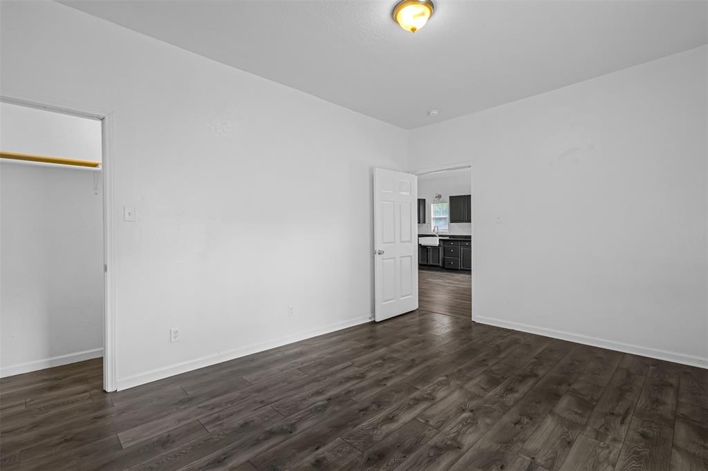 100 West Munson Street Denison, TX 75021 - Photo 10 of 12 a view of empty room with wooden floor