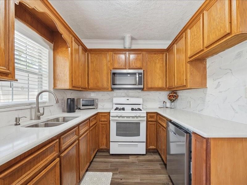 1801 Hussion Street Houston, TX 77003 - Photo 10 of 20 a kitchen with stainless steel appliances granite countertop a sink stove and microwave