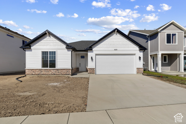 205 East 690th Street North Logan, UT 84321 - Photo 2 of 52 White horizontal siding exterior with a dark roof and brick lower facade