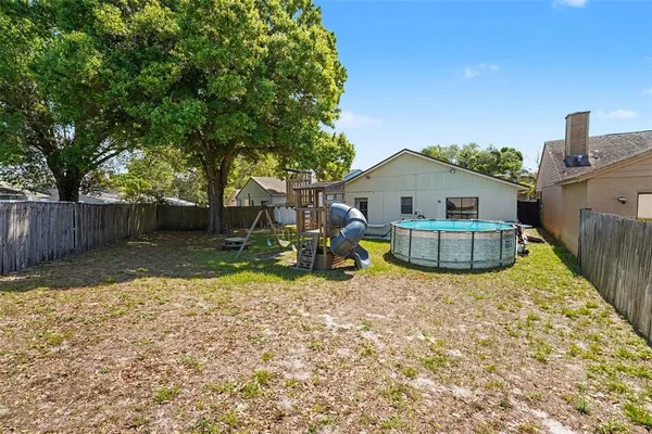 a view of a house with backyard porch and sitting area