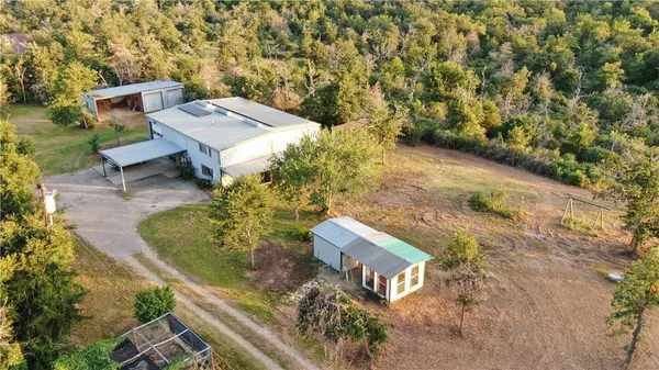 an aerial view of a house with a yard basket ball court and outdoor seating