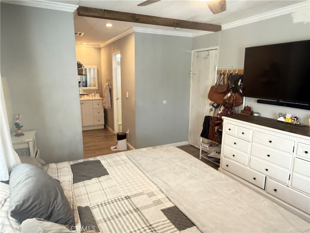 626 Dearborn, Unit 7 Redlands, CA 92374 - Photo 7 of 12 a bedroom with a bed and a flat screen tv