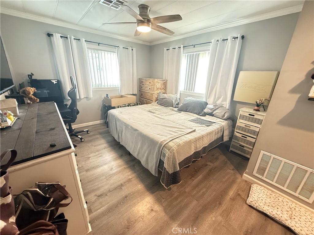 626 Dearborn, Unit 7 Redlands, CA 92374 - Photo 10 of 12 a bedroom with a bed and wooden floor