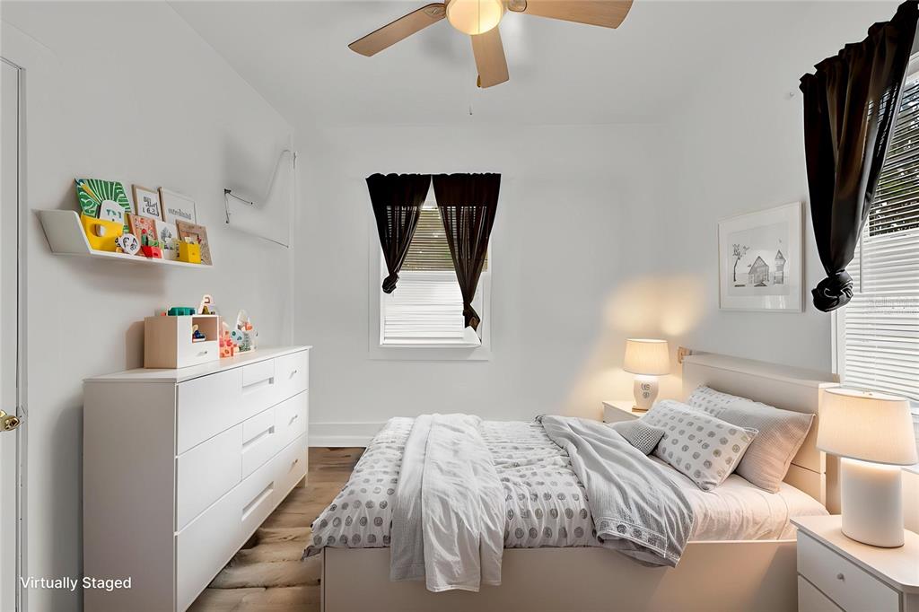 520 Dora Avenue Tavares, FL 32778 - Photo 12 of 17 a bedroom with a bed and a flat screen tv