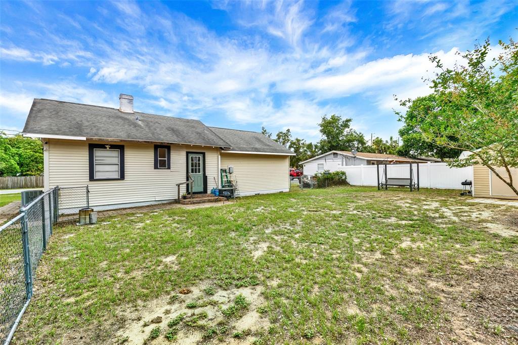 520 Dora Avenue Tavares, FL 32778 - Photo 17 of 17 a backyard of a house with table and chairs