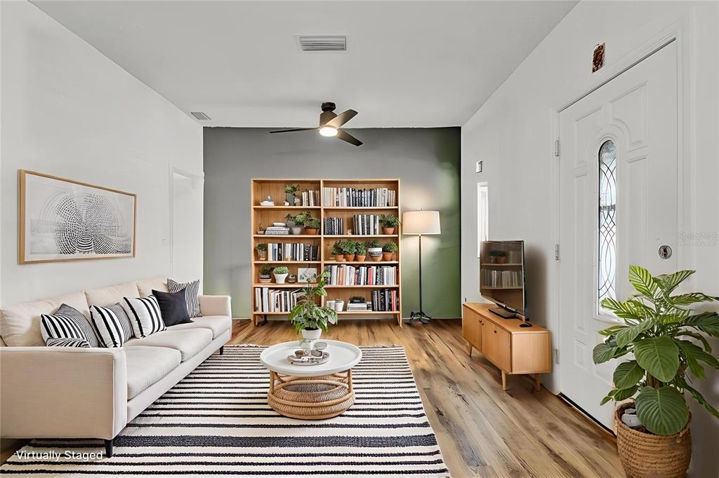 520 Dora Avenue Tavares, FL 32778 - Photo 3 of 17 a living room with furniture and a bookshelf