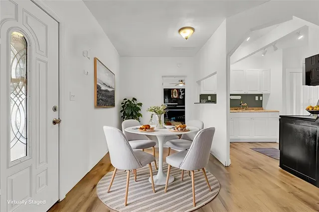 a view of a dining room with furniture and wooden floor