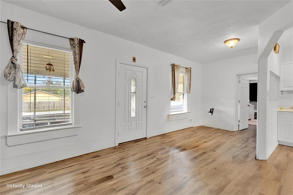 520 Dora Avenue Tavares, FL 32778 - Photo 6 of 17 a view of empty room with wooden floor and fan