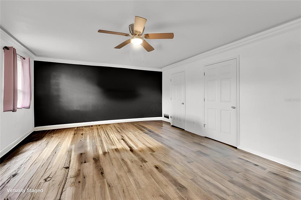 520 Dora Avenue Tavares, FL 32778 - Photo 8 of 17 an empty room with wooden floor and windows