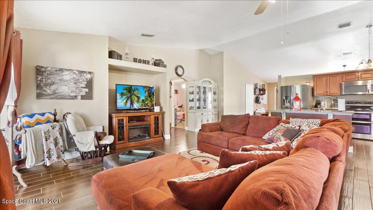 7220 Freeport Road Cocoa, FL 32927 - Photo 15 of 25 a living room with furniture and a flat screen tv